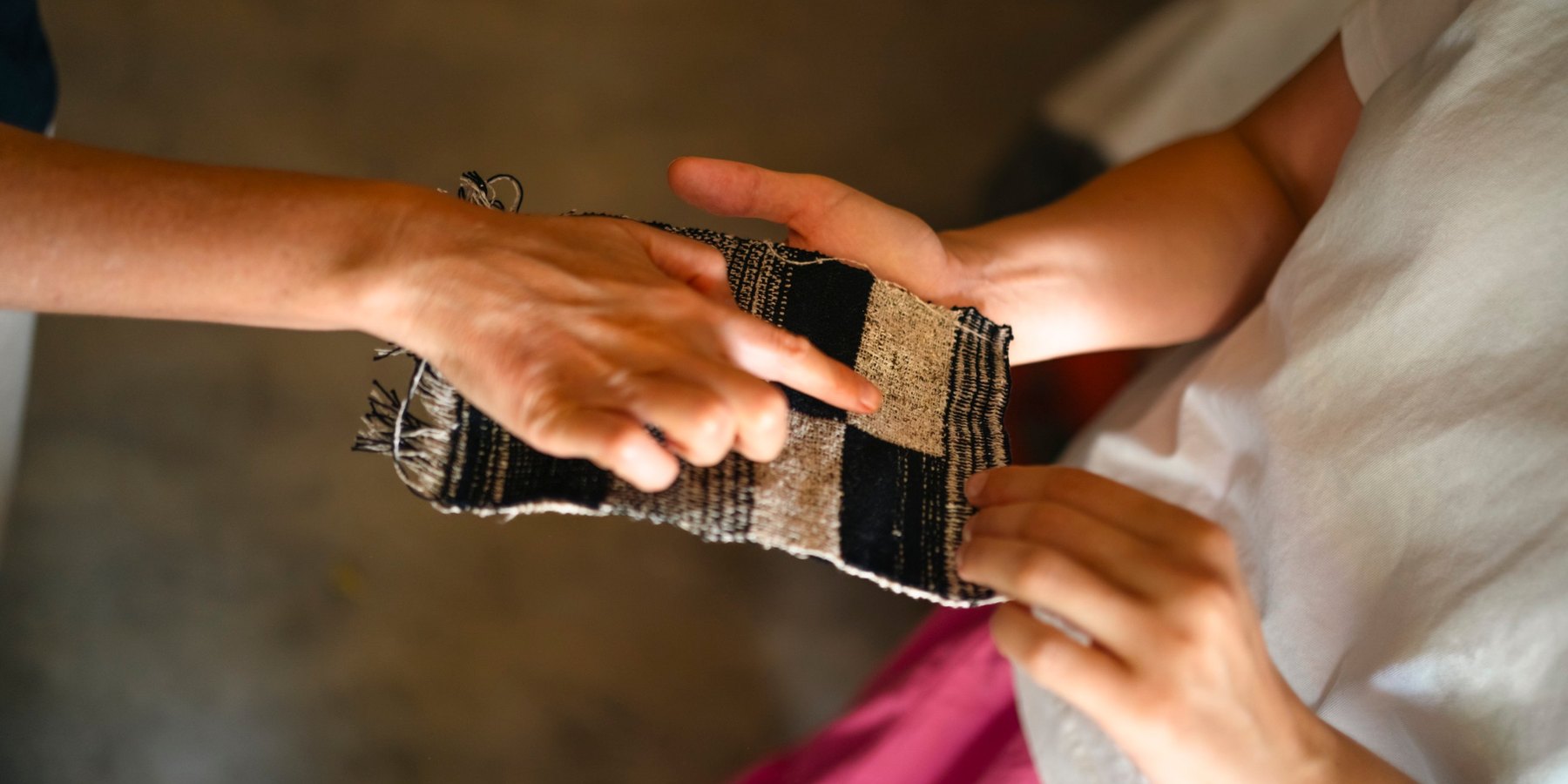 Hands holding a woven sample